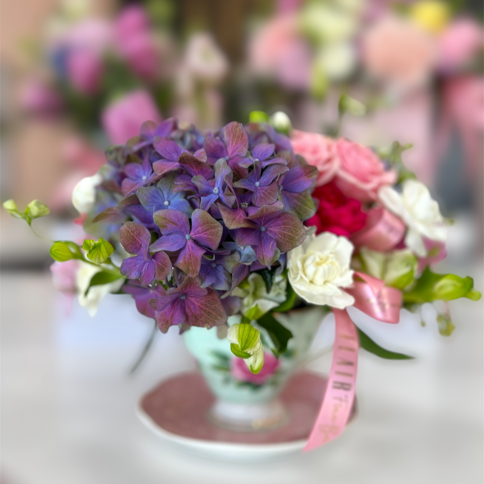 Tea Time in Bloom – Designer’s Choice Teacup Arrangement - Flair Flower Bar & Studio