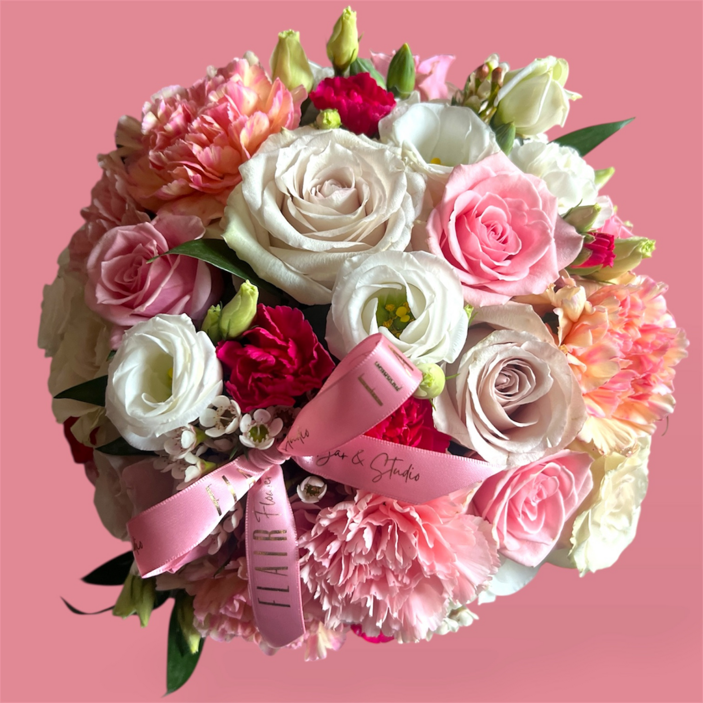 Bouquet of flowers with a pink ribbon on a pink background