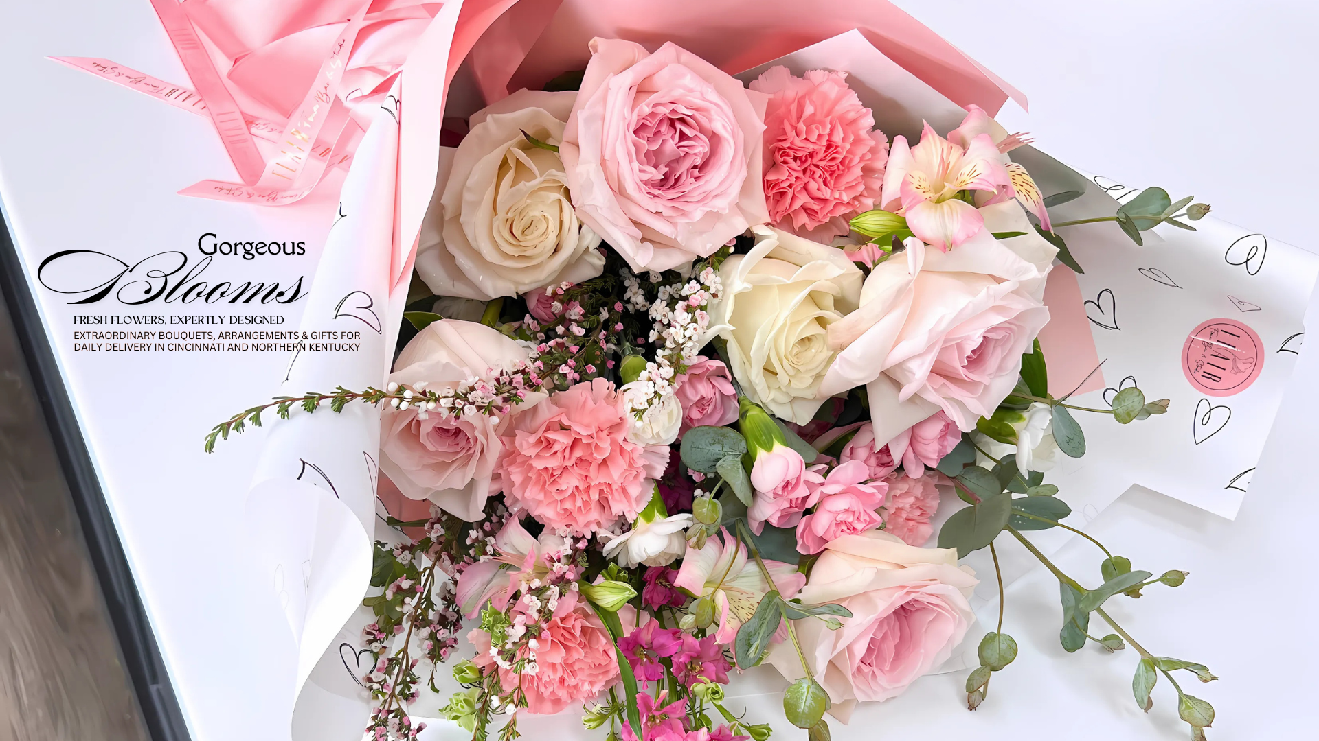Bouquet of pink and white flowers with a Flair Flower Bar & Studio Branding wrap.