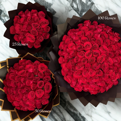 Three bouquets of red roses in different quantities on a marble surface.