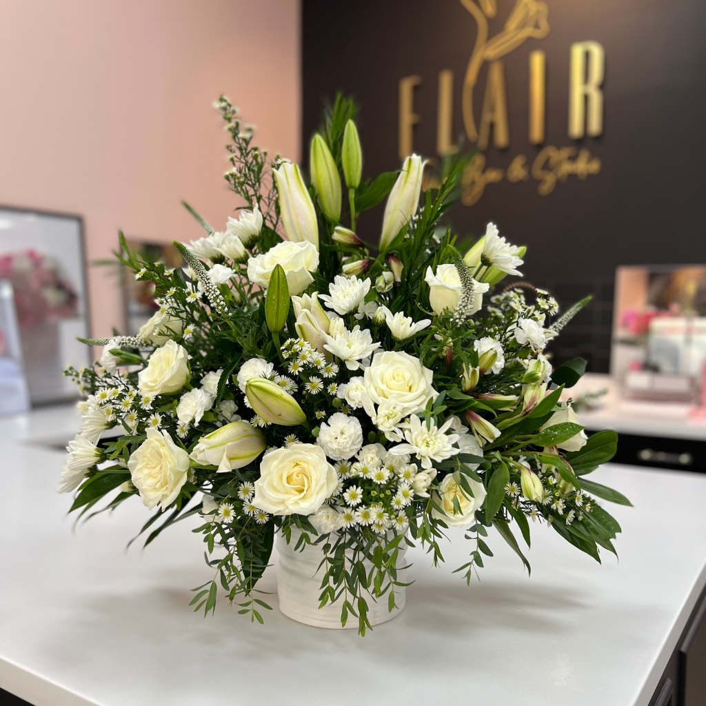 Grand white sympathy floral display, 20–24 inches wide, in ceramic planter