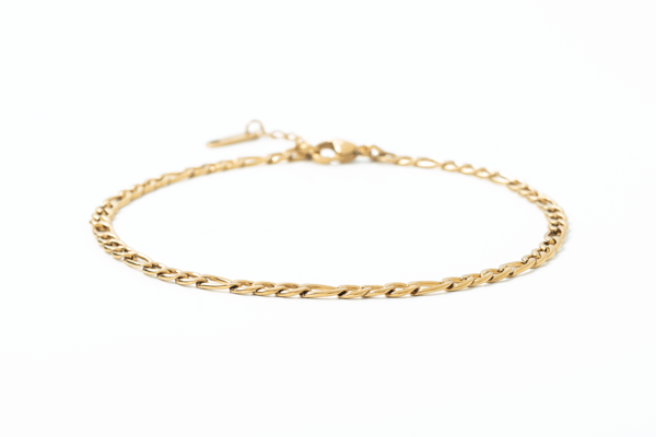 Gold chain anklet on a white background