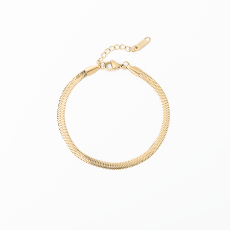 Gold herringbone bracelet on a white background