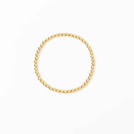 Gold beaded bracelet on a white background