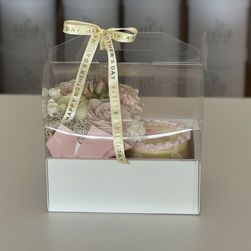 Gift box with flowers and a ribbon on a plain background