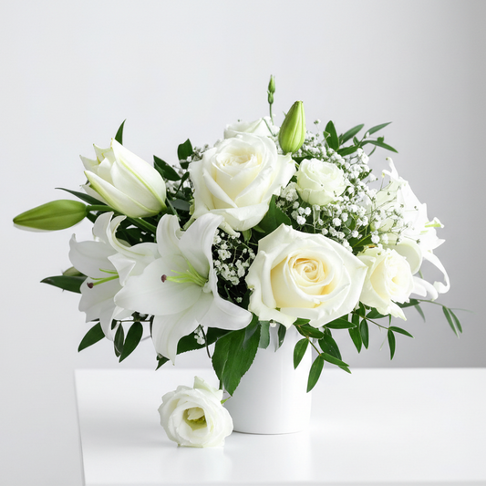 Funeral bouquet of white flowers with green leaves on a light gray background