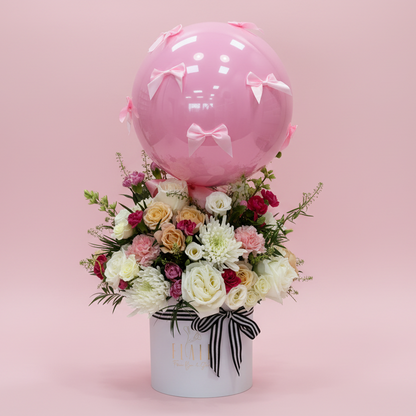 Floral arrangement with a pink balloon with luxury box and pink bows