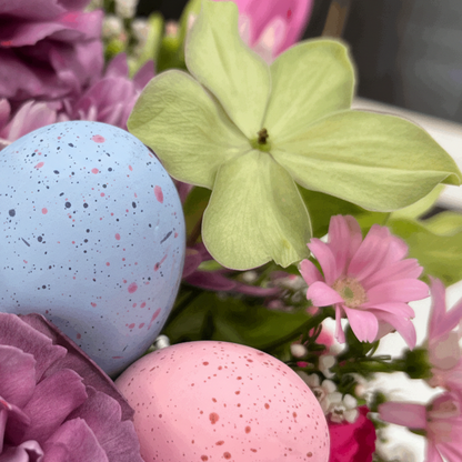 Speckled blue and pink eggs among flowers from Flair Flower Bar & Studio