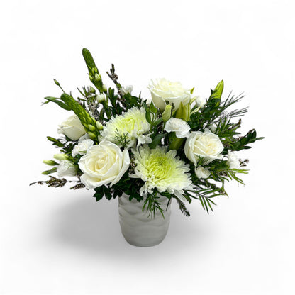 Bouquet of white and green flowers in a vase on a white background