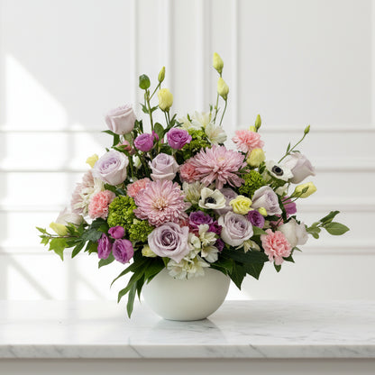 Funeral flowers in a vase on a table with a blurred background for sympathy funeral delivery in Florence, Kentucky