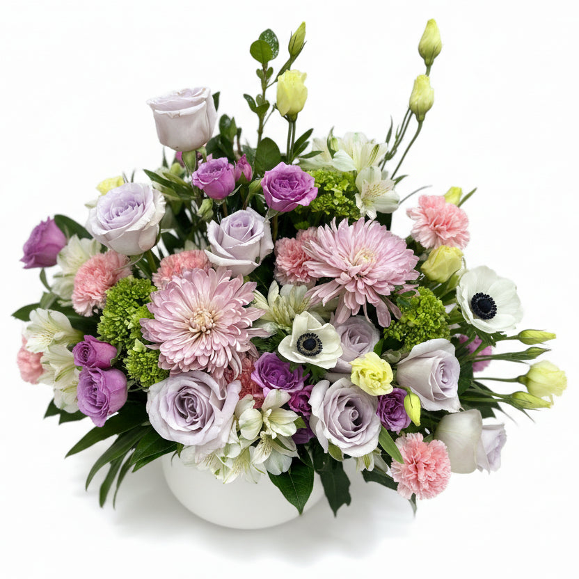 Sympathy Funeral Flower Arrangement of pastel-colored flowers including roses and hydrangeas.