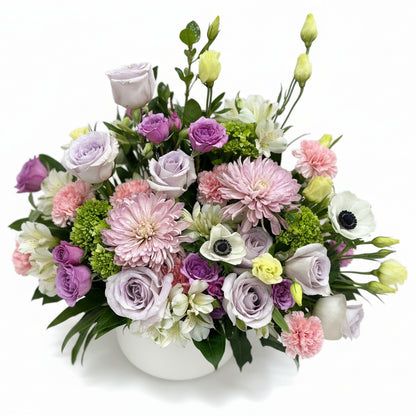 Sympathy Funeral Flower Arrangement of pastel-colored flowers including roses and hydrangeas.