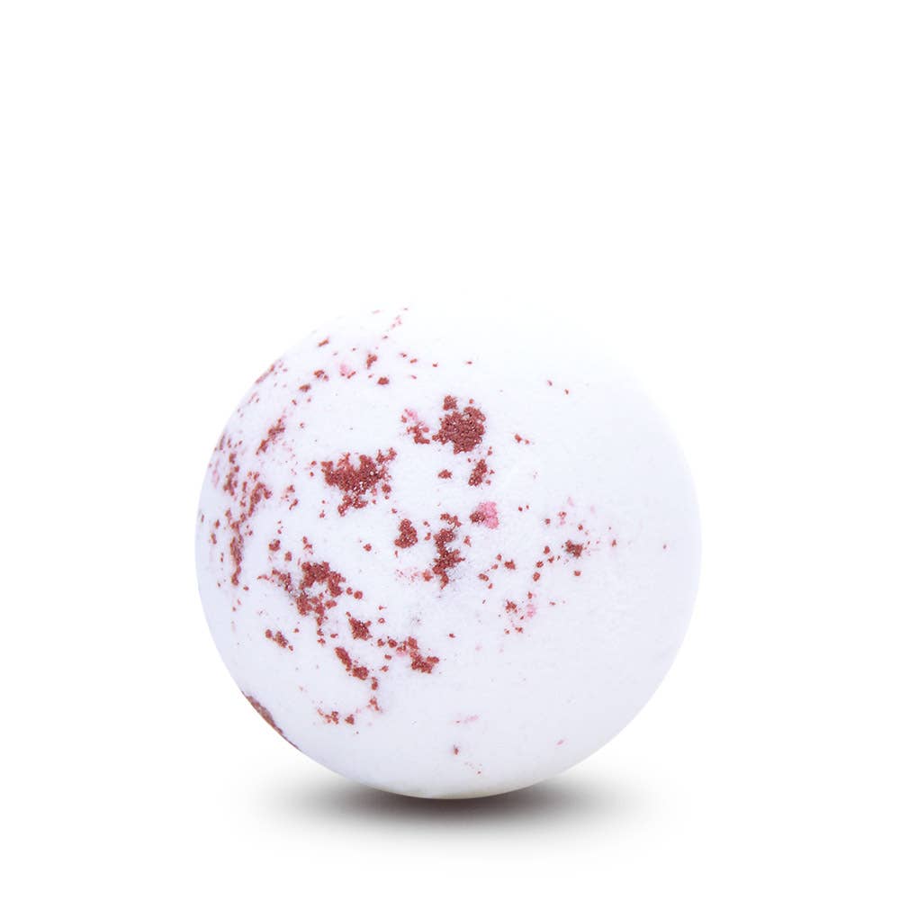 White bath bomb with red specks on a white background
