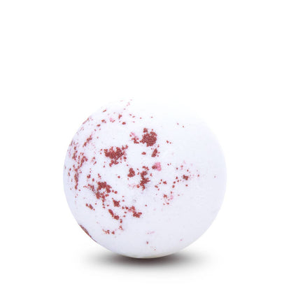 White bath bomb with red specks on a white background