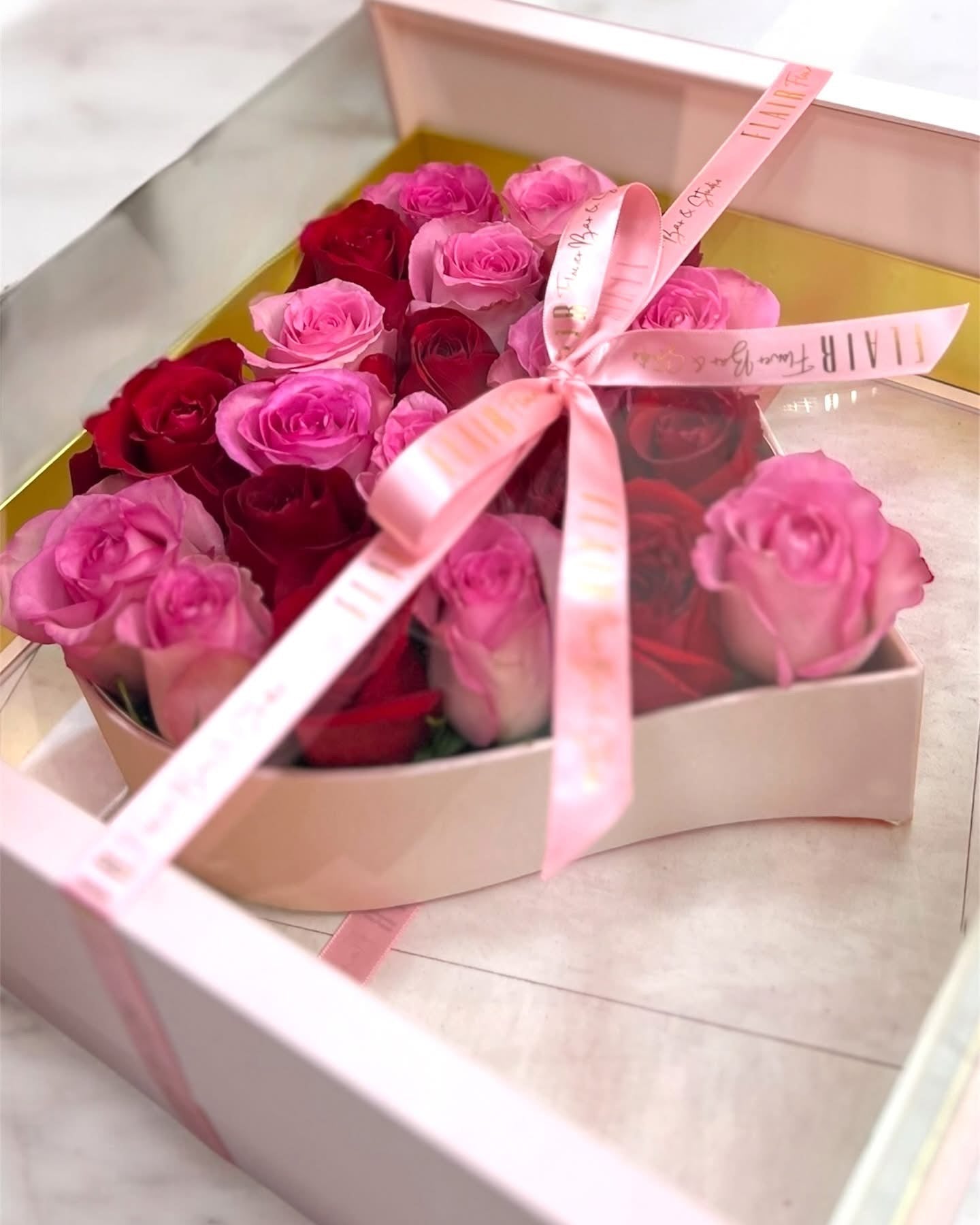 Bouquet of pink and red roses in a box with a pink ribbon for local delivery in Cincinnati and Florence, Kentucky