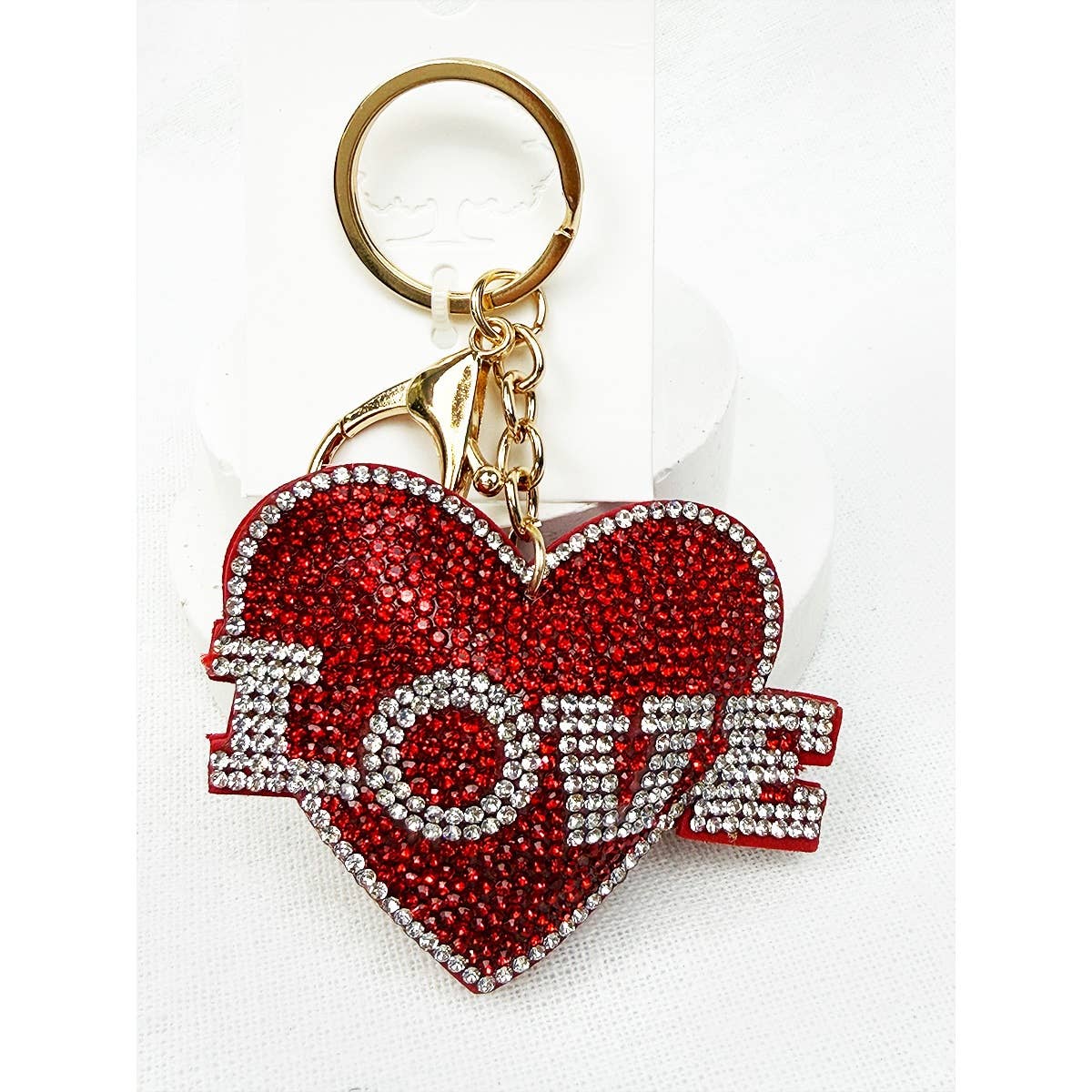 Red heart-shaped keychain with 'I LOVE' text on a white background