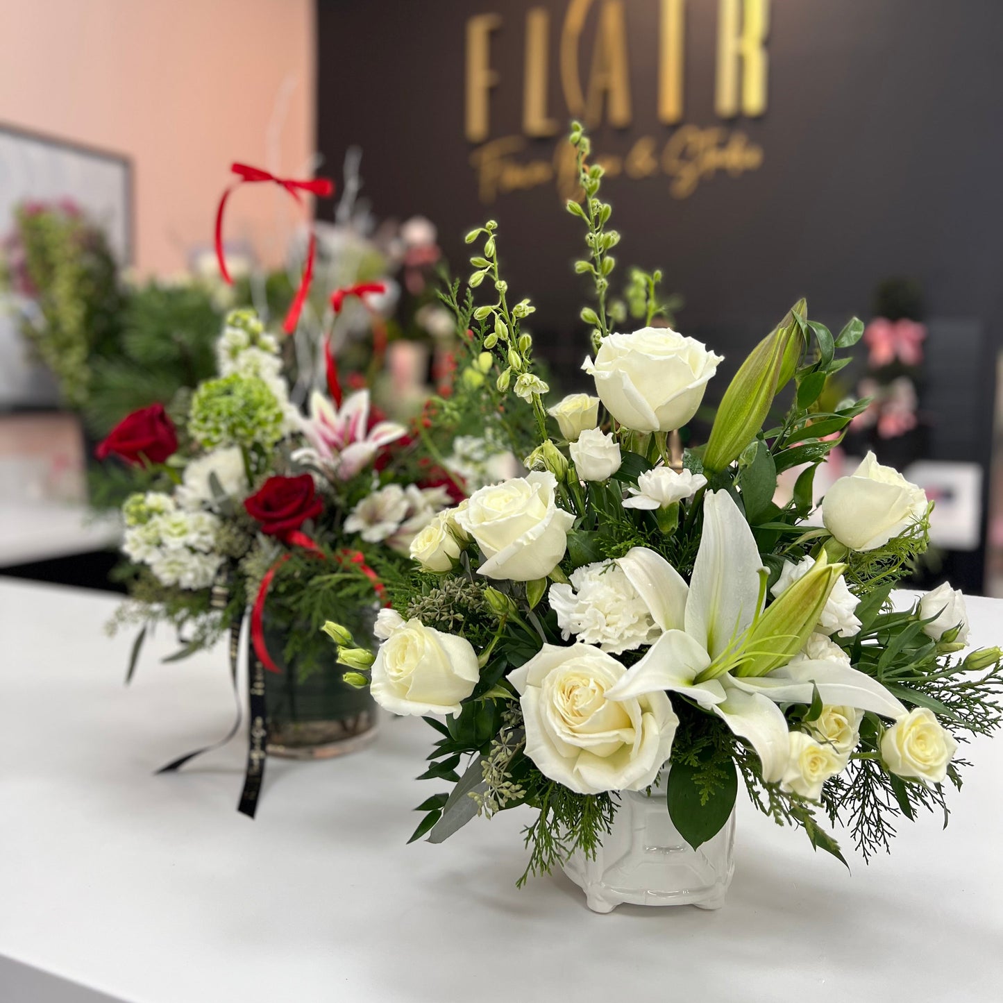Floral arrangements on a table with 'Flair' logo in the background