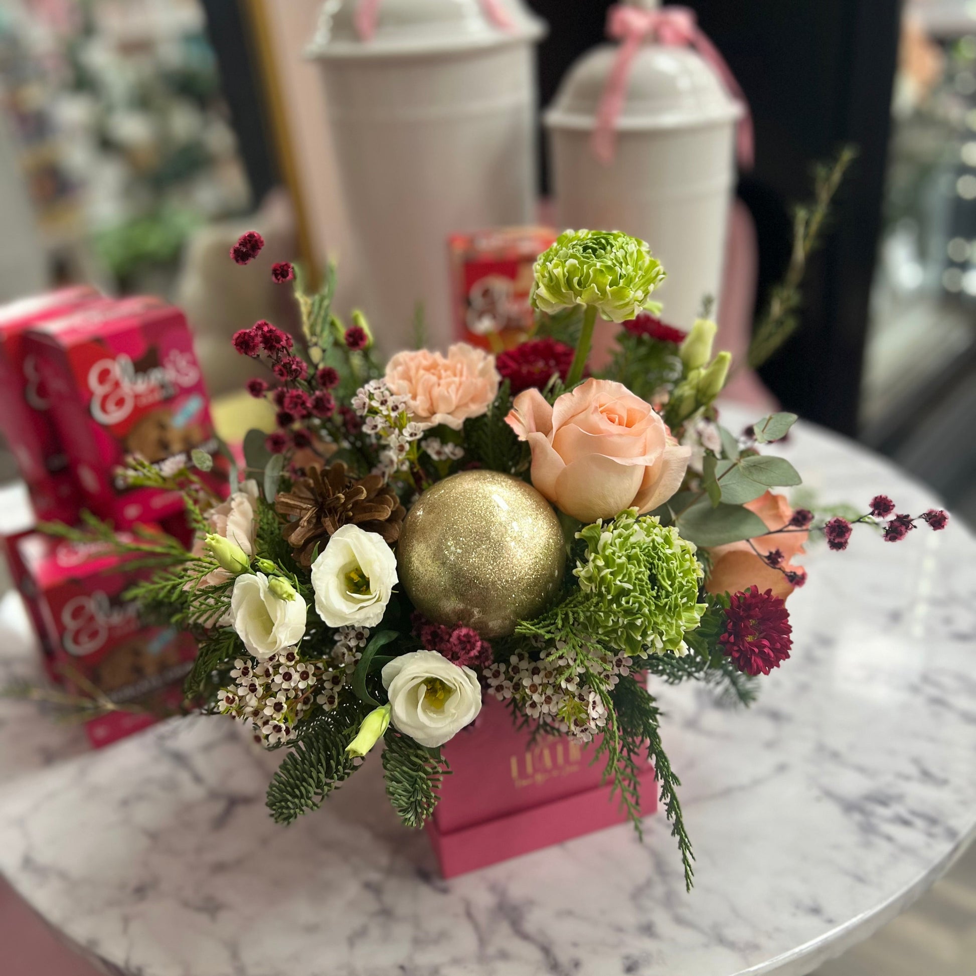 Floral arrangement with a gold ornament on a marble table
