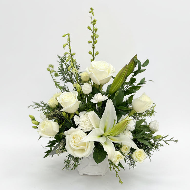 Floral arrangement with white flowers in white background