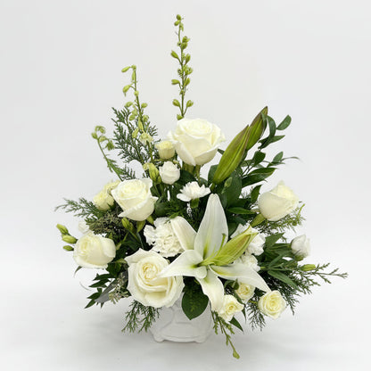 Floral arrangement with white flowers in white background