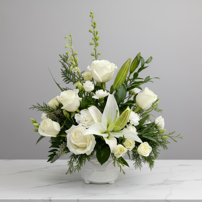 Arrangement of white flowers in a vase on a gray background