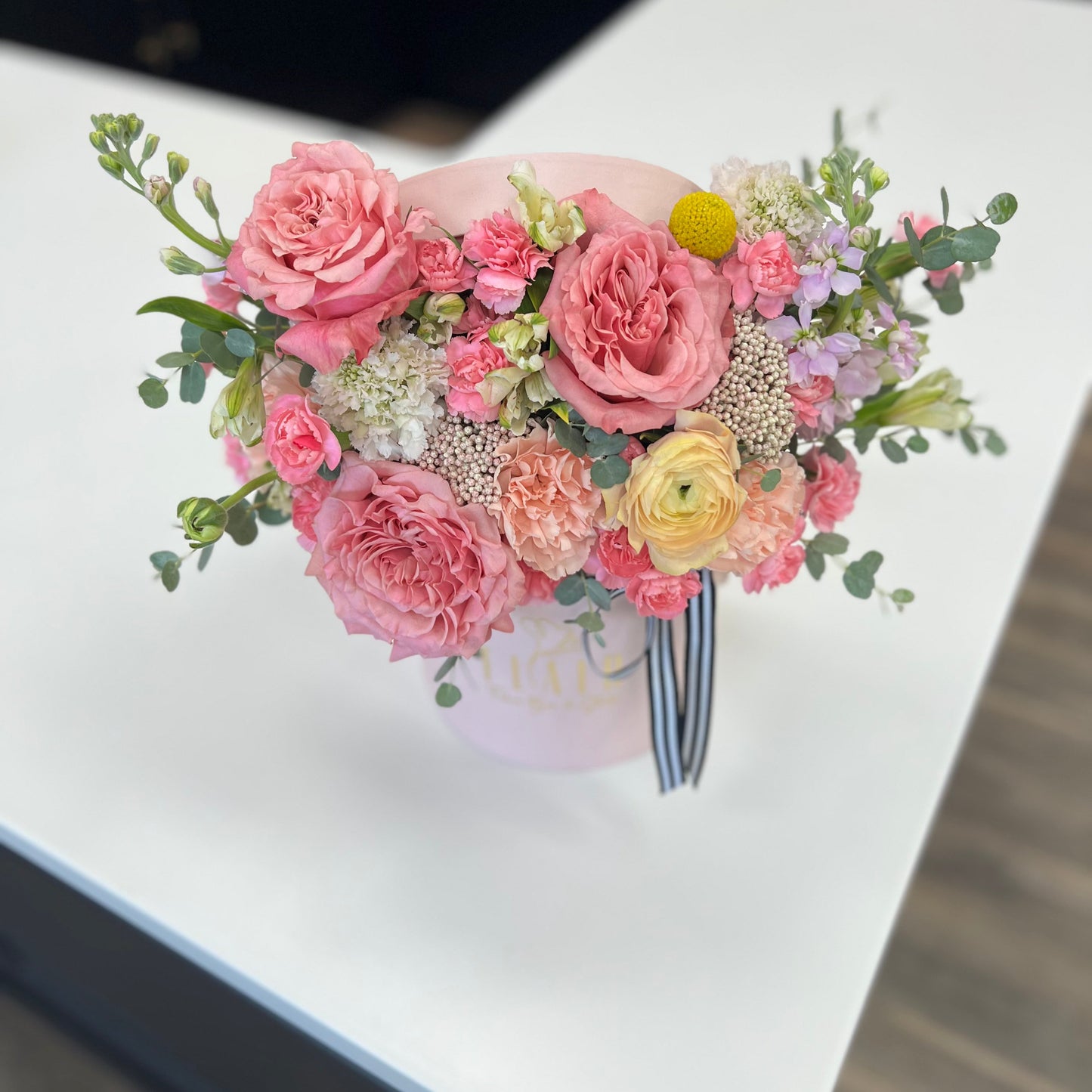 Top view of arrangement of pink and yellow flowers in a luxury box for local delivery in Cincinnati from Flair Flower Bar in Florence, Kentucky