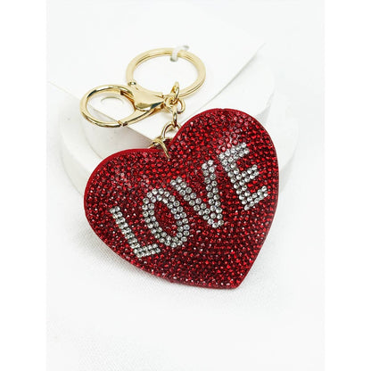 Red heart-shaped keychain with 'LOVE' text on a white background