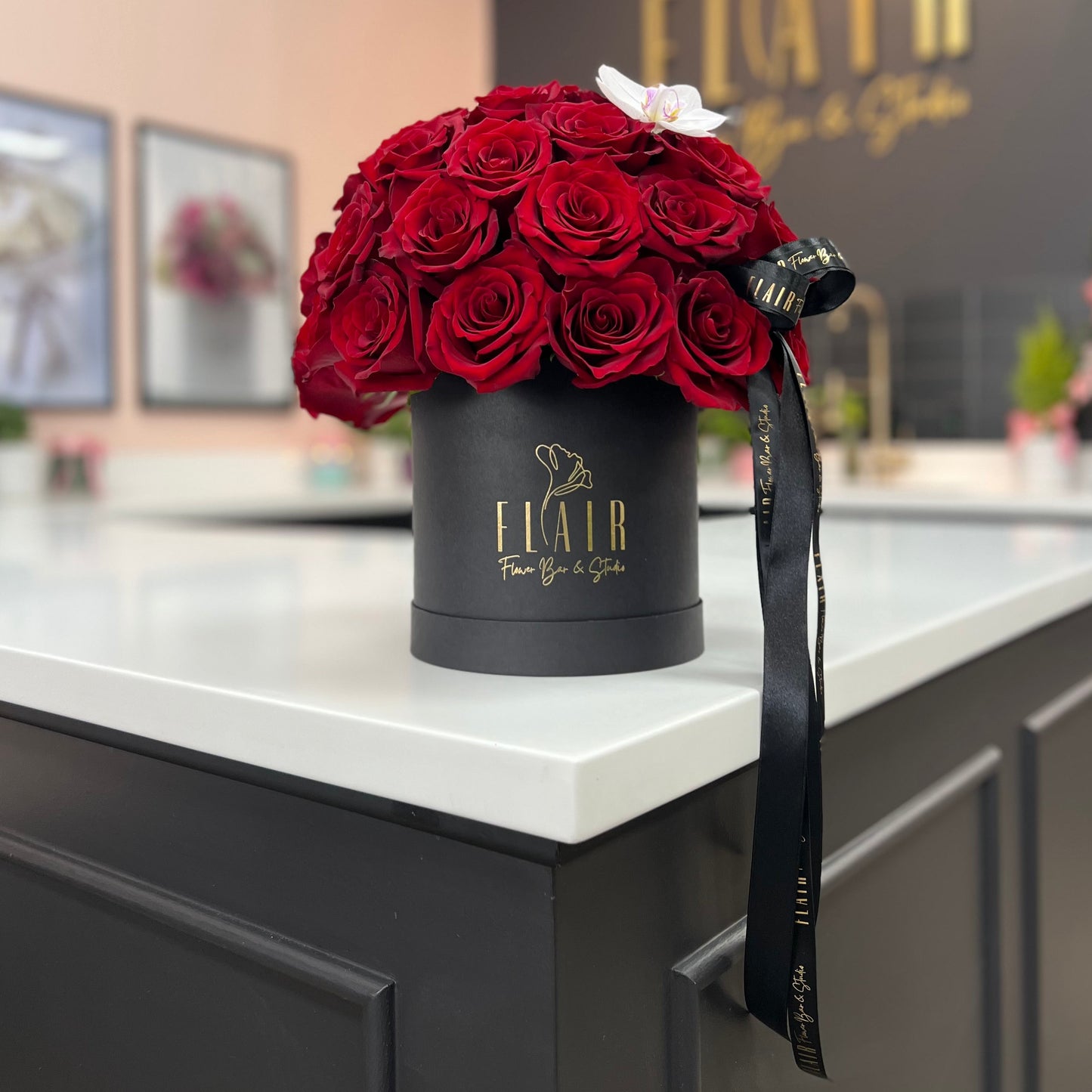 Black box with red roses on a counter in a store with Flair Flower Bar in Florence Kentucky