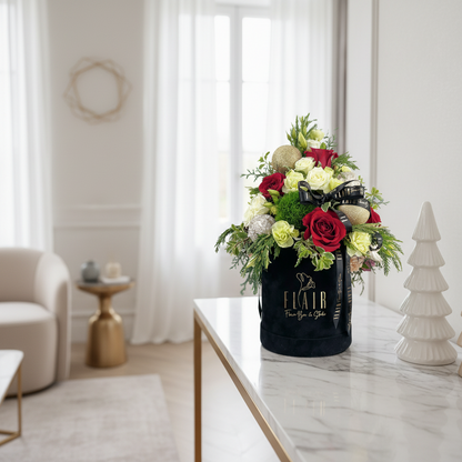 Floral arrangement in a black container on a marble table with a blurred background