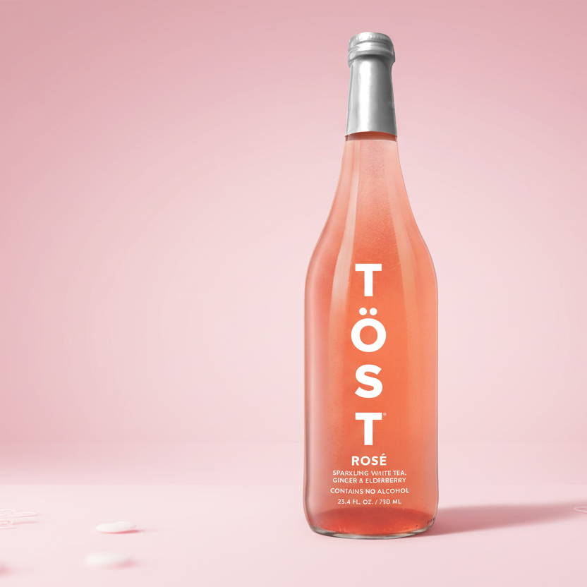 Bottle of Töst Rosé on a pink background
