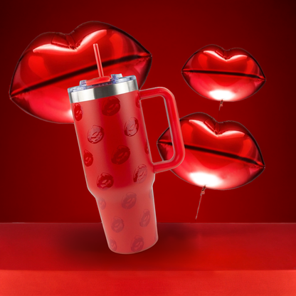 Red tumbler with lip designs on a red background with red lip-shaped balloons.