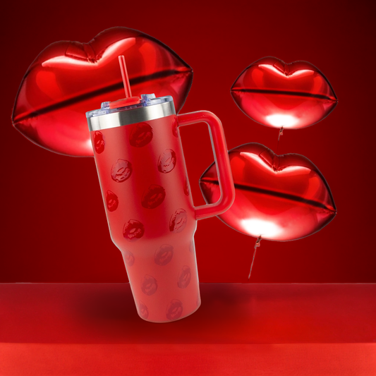 Red tumbler with lip designs on a red background with red lip-shaped balloons.