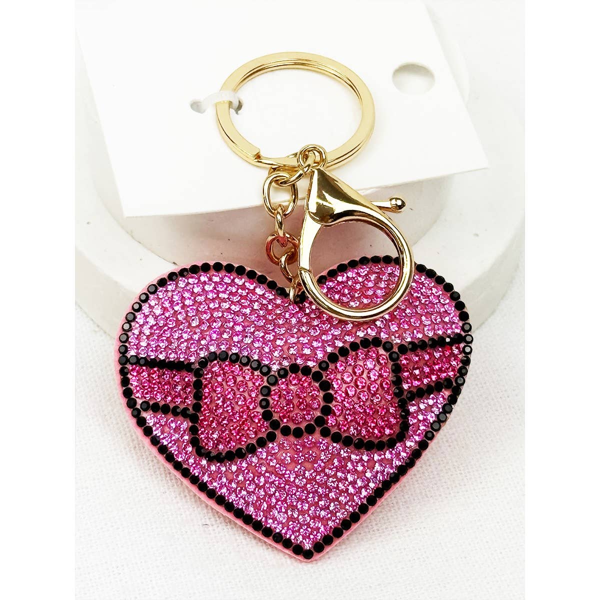 Heart-shaped keychain with pink and black design on a white background