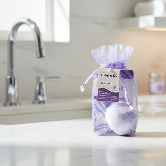 Lavender salt, soap, and mini gift set in a clear bag with purple ribbon on a white background.