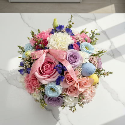 Colorful bouquet of flowers in a decorative box on a white background