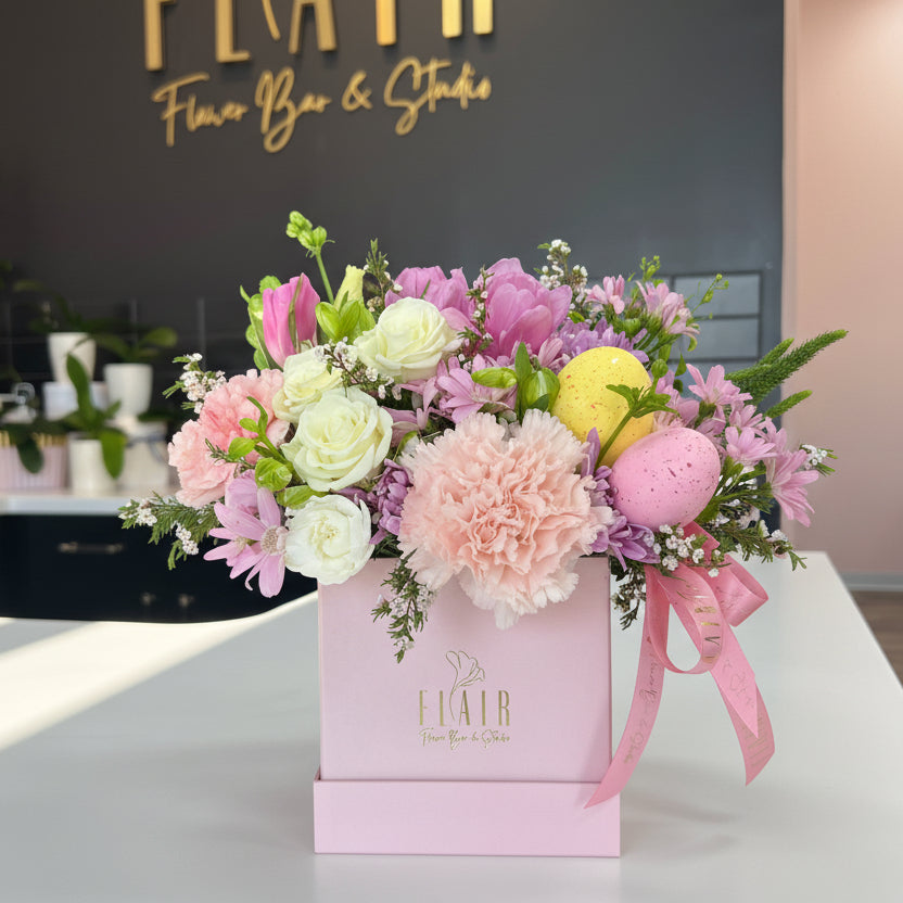 Floral arrangement in a box with 'Flair' branding in the background