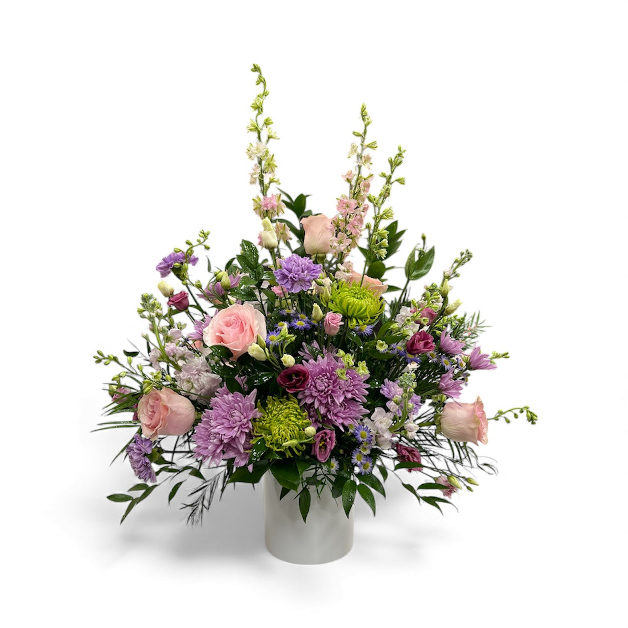 Colorful flower arrangement in a white vase on a white background