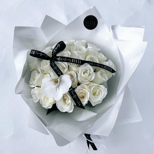 All White 25 Stem Rose Bouquet, Ramo Buchon, wrapped in white paper and topped with signature ribbon and white orchid, created by Flair Flower Bar & Studio in Florence, Kentucky near Cincinnati, Ohio