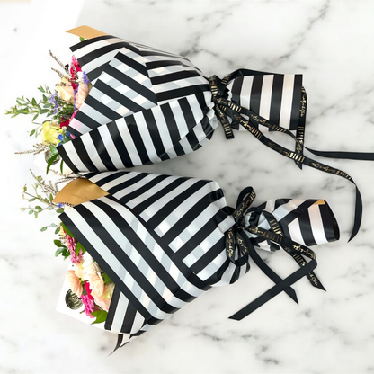 Black and white striped bouquets on a marble surface.