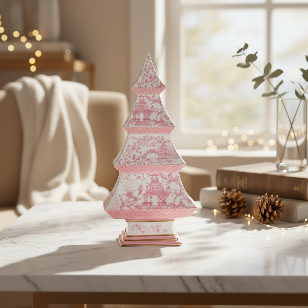 Decorative pink and white tree on a table with a cozy indoor setting.