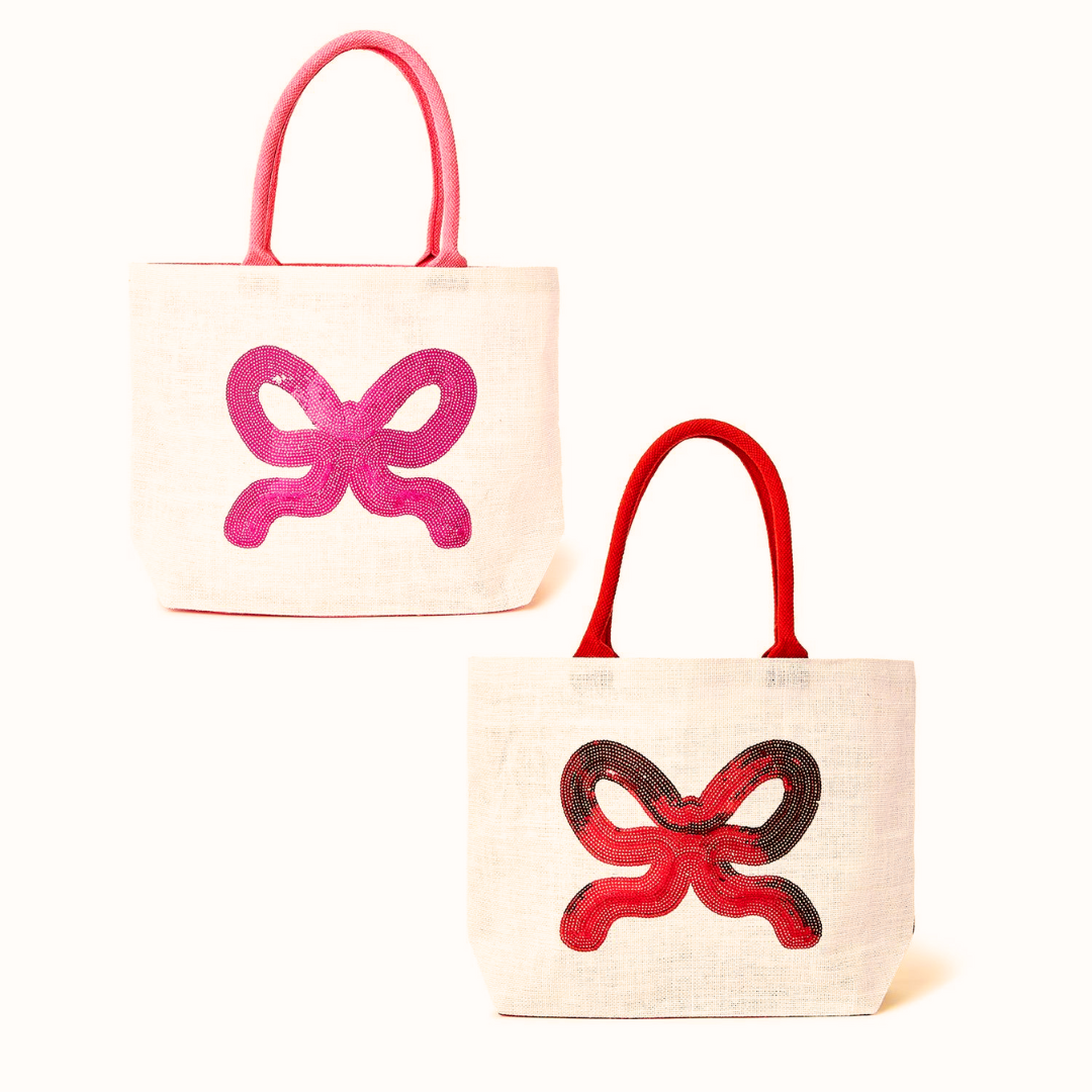 Two large tote bags with sequin bow designs on a white background