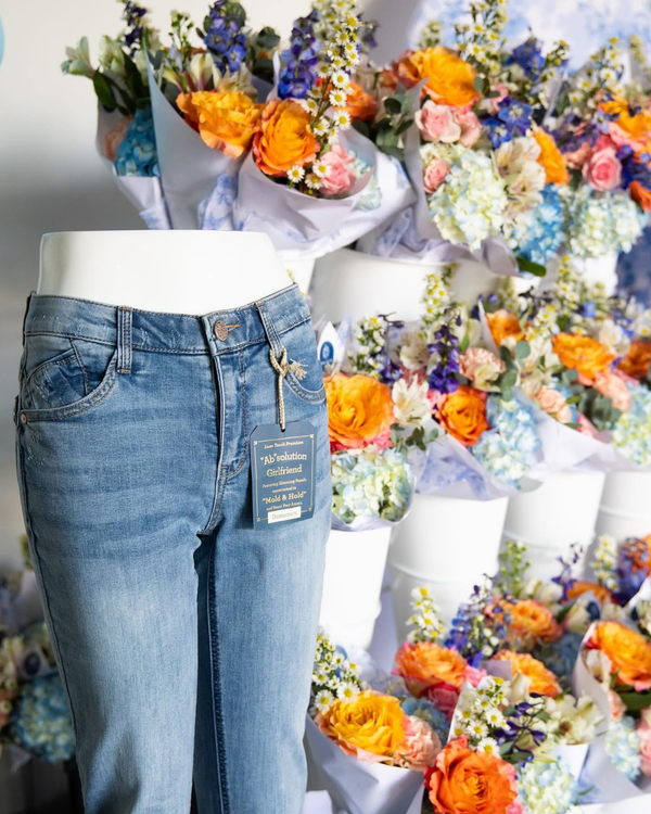 Democracy Jeans_Garage on York Event_Brand Launch_Blue jeans on a mannequin with a bouquet of flowers in the background _ Cincinnati_Northern Kentucky