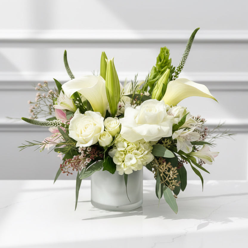 Bouquet of white flowers on a white surface with a blurred background