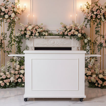 A white flower bar cart with black caster wheels for rent, photographed in a luxury wedding event space by Flair Flower Bar & Studio