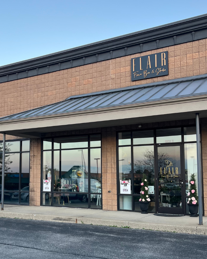 Brick building with a glass facade and 'Lair' sign on a clear day