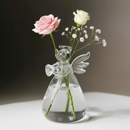 Clear glass vase with angel design holding flowers on a neutral background