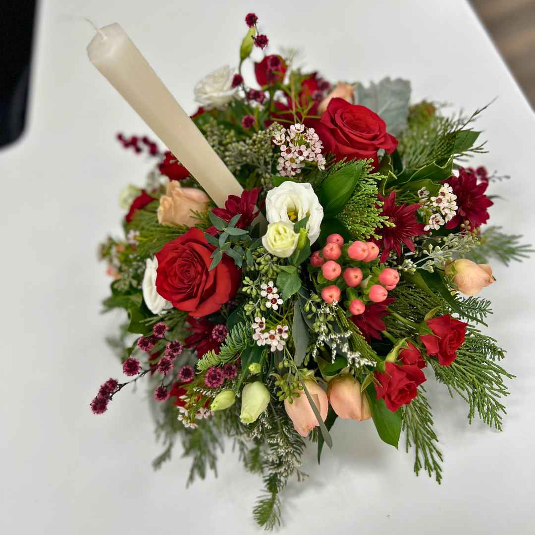 Elegant Christmas table centerpiece with red and white blooms