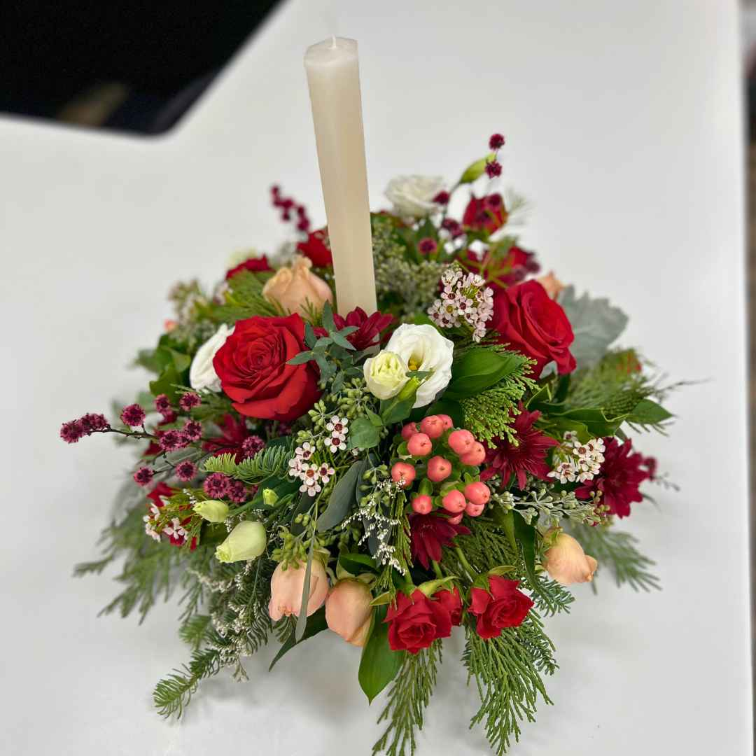 Holiday Spice Christmas floral arrangement with taper candle