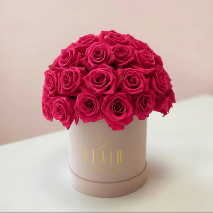 Pink box with hot pink roses on a blurred background