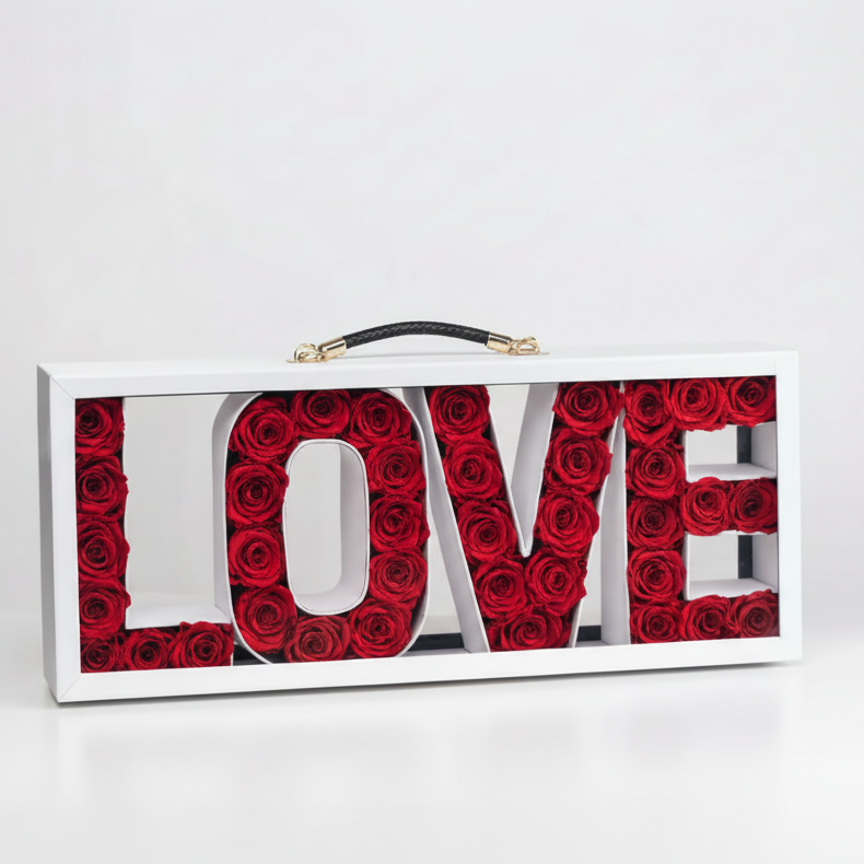 Decorative sign with 'LOVE' spelled out using red roses on a white background